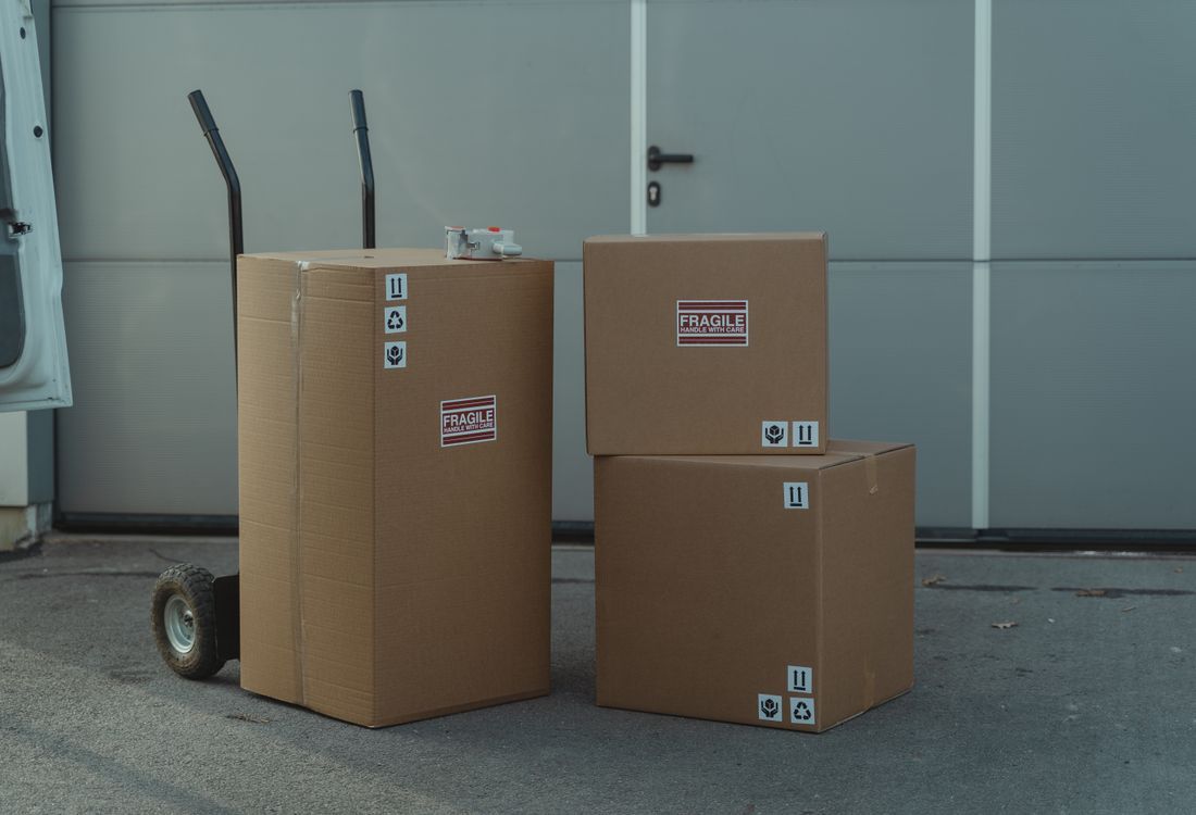 Flat-folded RSC carton blanks stacked on the factory floor before set-up