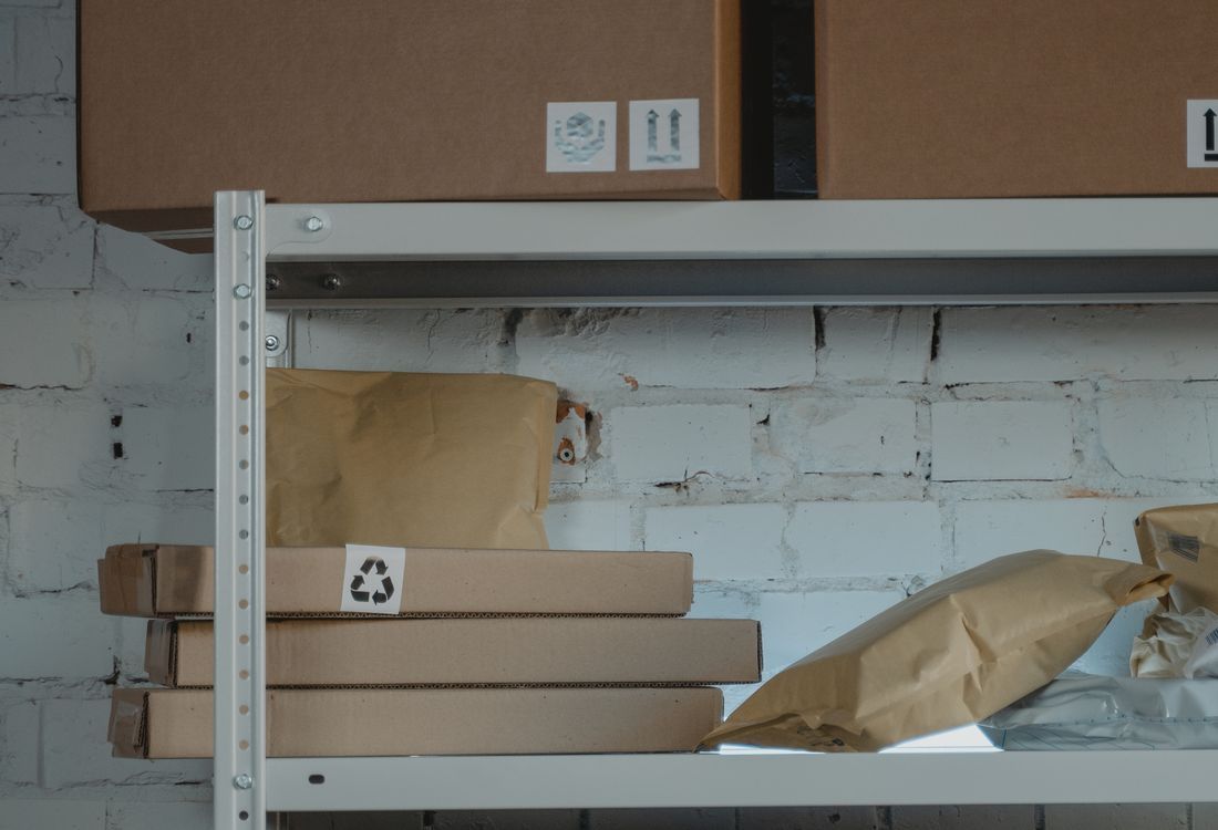 Finished corrugated cartons organised on warehouse shelving awaiting dispatch